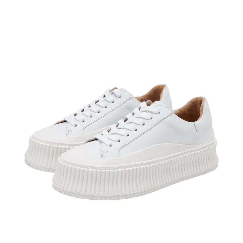 Women's black suede platform trainers with cross-lace binding and thick soles