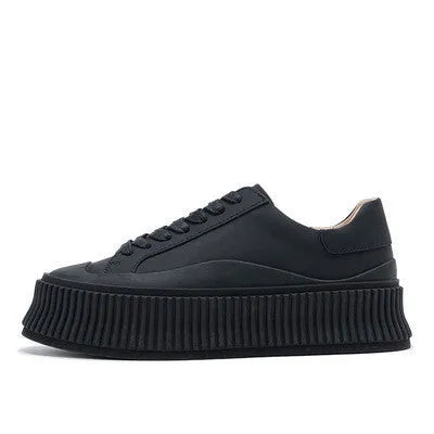 Women's black suede platform trainers with cross-lace binding and thick soles