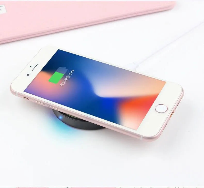 Square Qi wireless charging base in six colour options on a wood surface.
