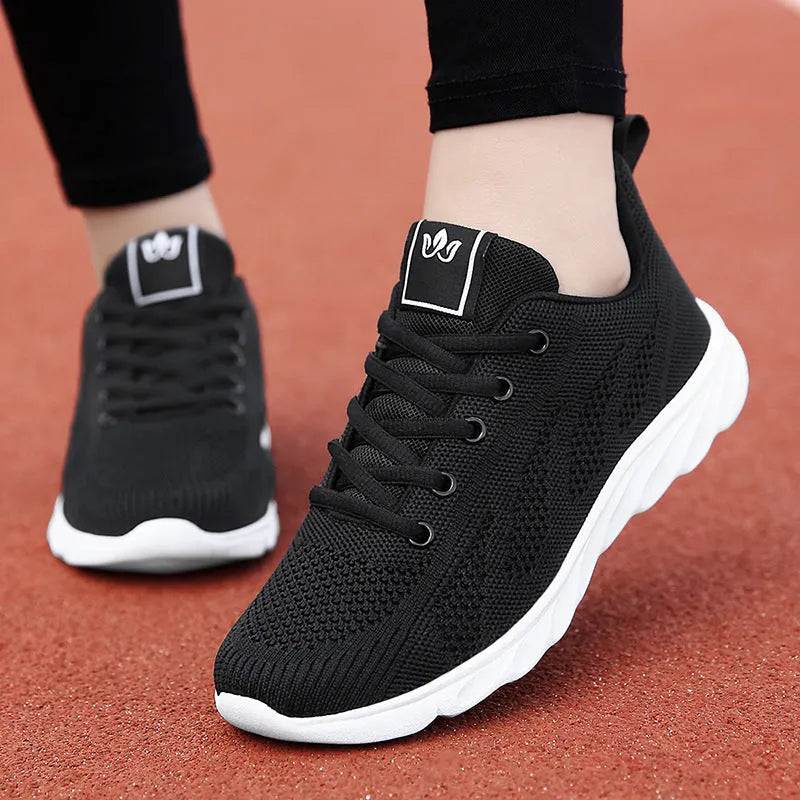 Women's black high-top casual sneakers with a cross-strap and hollow-out design on a white background.