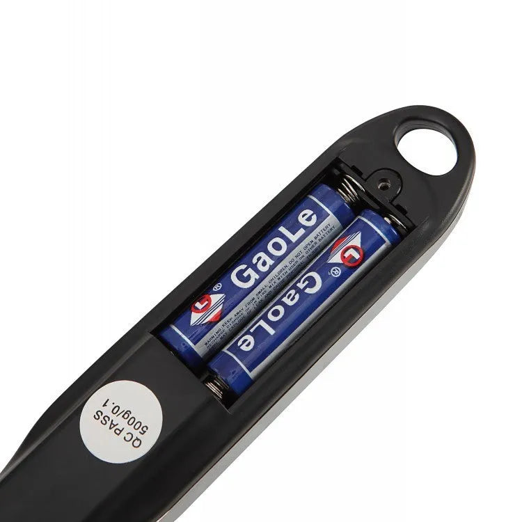 Digital measuring spoon with electronic display showing weight measurement in grams