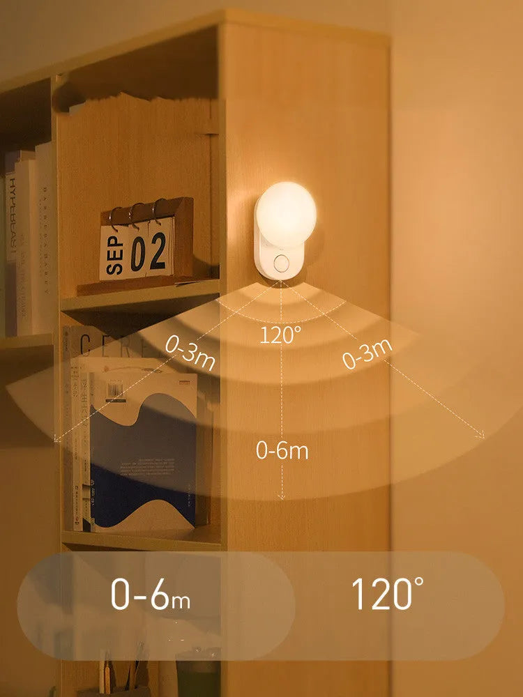 White Baseus rechargeable motion sensor bedside night light on a wooden surface.