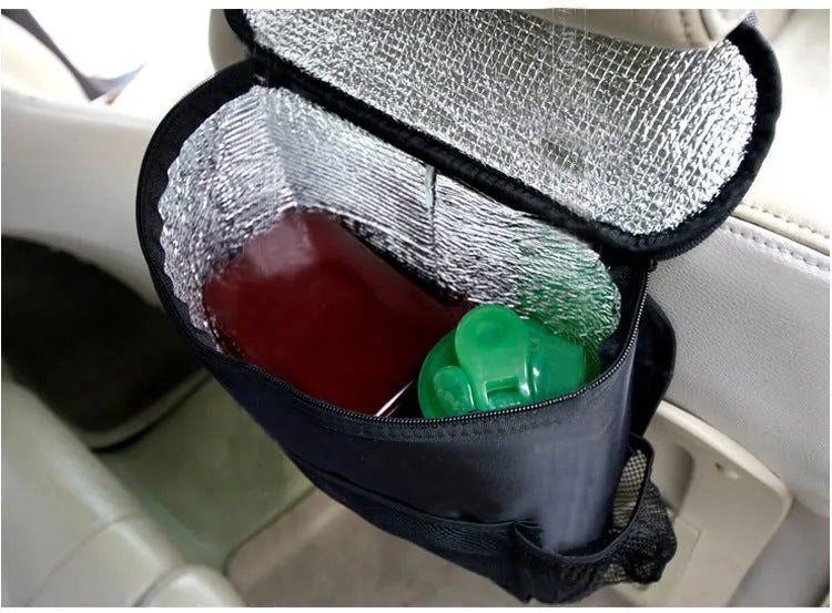 Black 600D Oxford cloth car trash storage bag with adjustable shoulder strap hanging on headrest