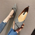 Red and black women's pointed toe shallow-mouth flats with a low flat heel on a white background.