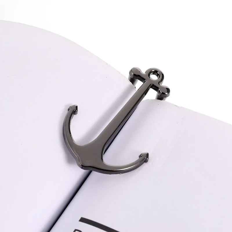 Creative metal bookmark page folder in rose gold colour against an open book
