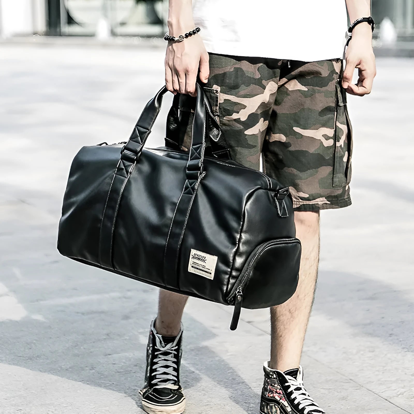 Black large capacity PU leather sports bag showing zipper opening and single shoulder strap.