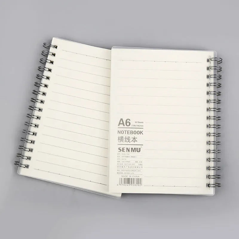 Creative coil notebook open showing grid pages, available in A5, B5, and A6 sizes