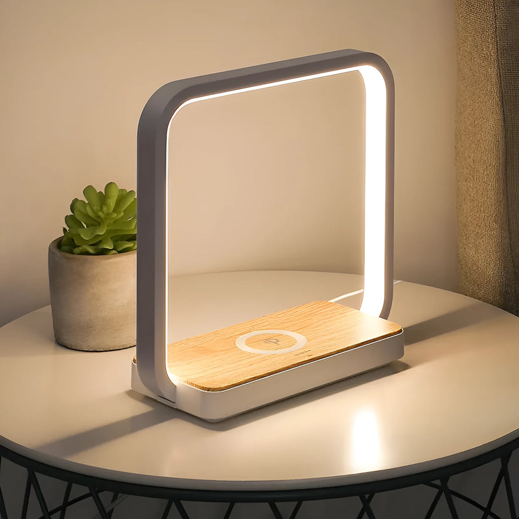 Modern white and gold smart bedside lamps with voice control and USB cable on a wooden table.