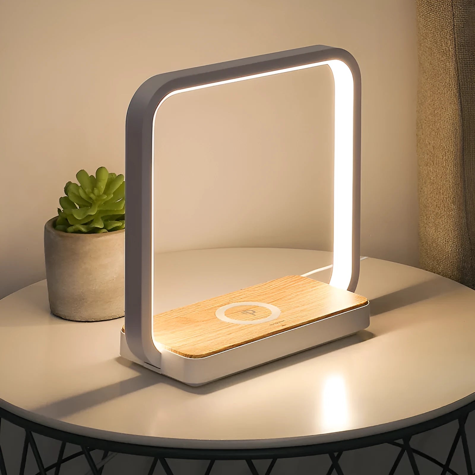 Modern white and gold smart bedside lamps with voice control and USB cable on a wooden table.