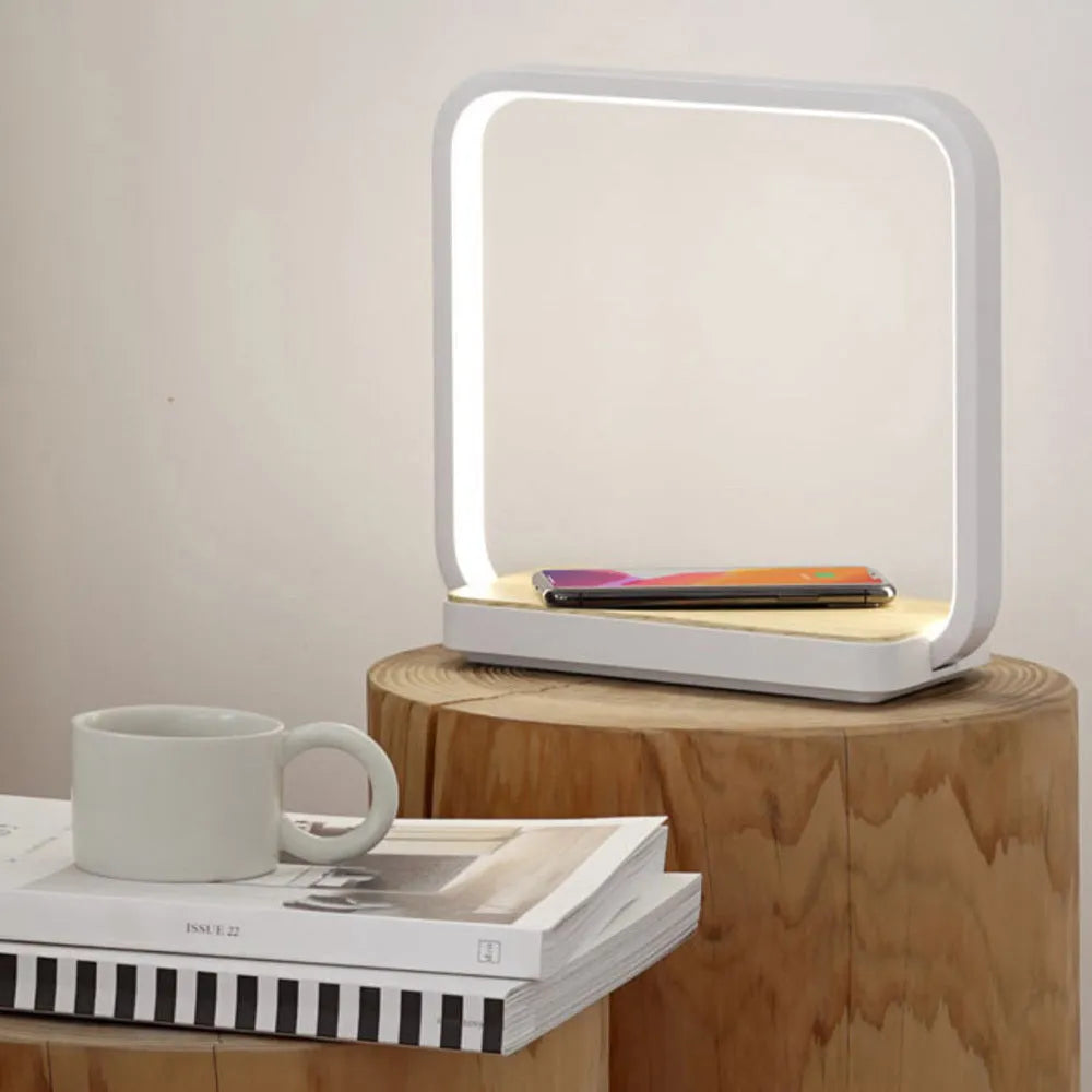 Modern white and gold smart bedside lamps with voice control and USB cable on a wooden table.