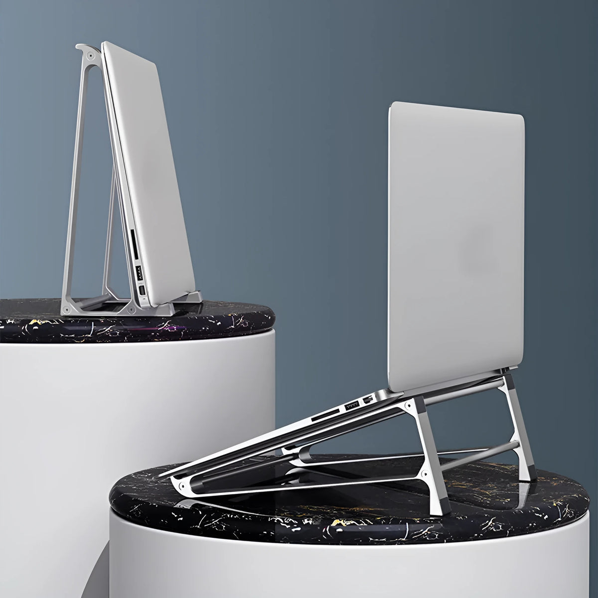 Aluminium alloy laptop stand with increased storage, 22.5 x 21 x 8.5 cm, in dark grey or silver.