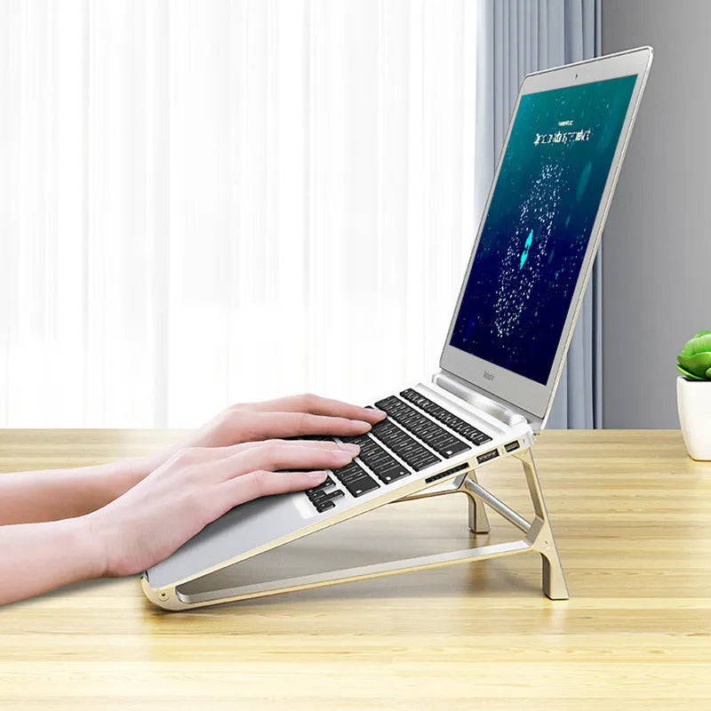 Aluminium alloy laptop stand with increased storage, 22.5 x 21 x 8.5 cm, in dark grey or silver.