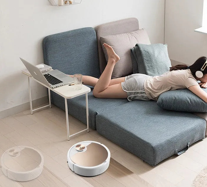 Gold intelligent robotic vacuum cleaner with touch panel and remote control on a hardwood floor.