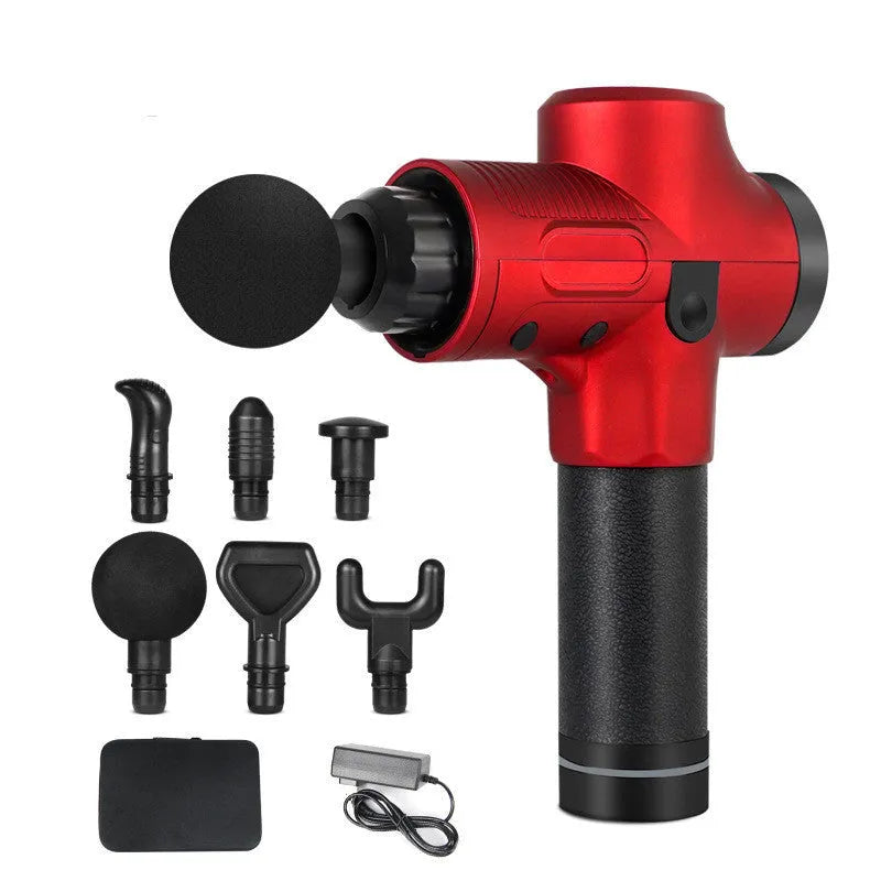 Black electric muscle massage gun with multiple interchangeable heads on a table.