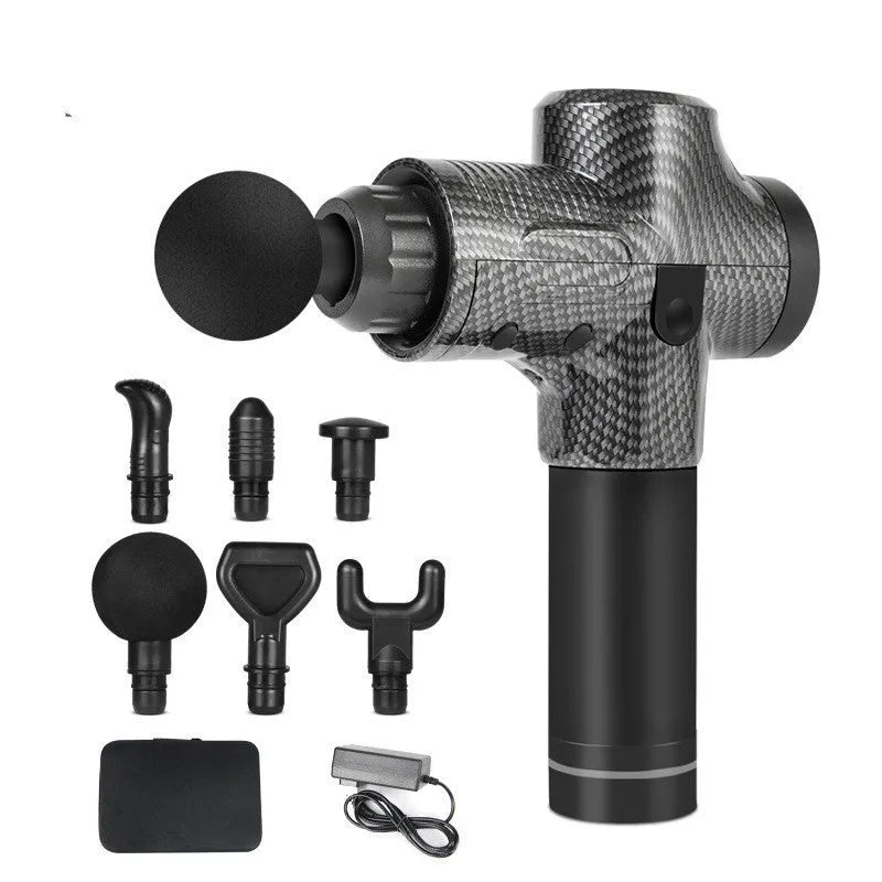 Black electric muscle massage gun with multiple interchangeable heads on a table.