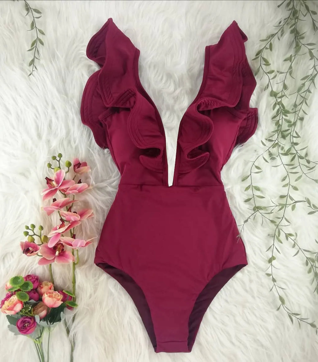 Blue printed one-piece swimsuit for women with one-shoulder ruffle and chest pad on white background