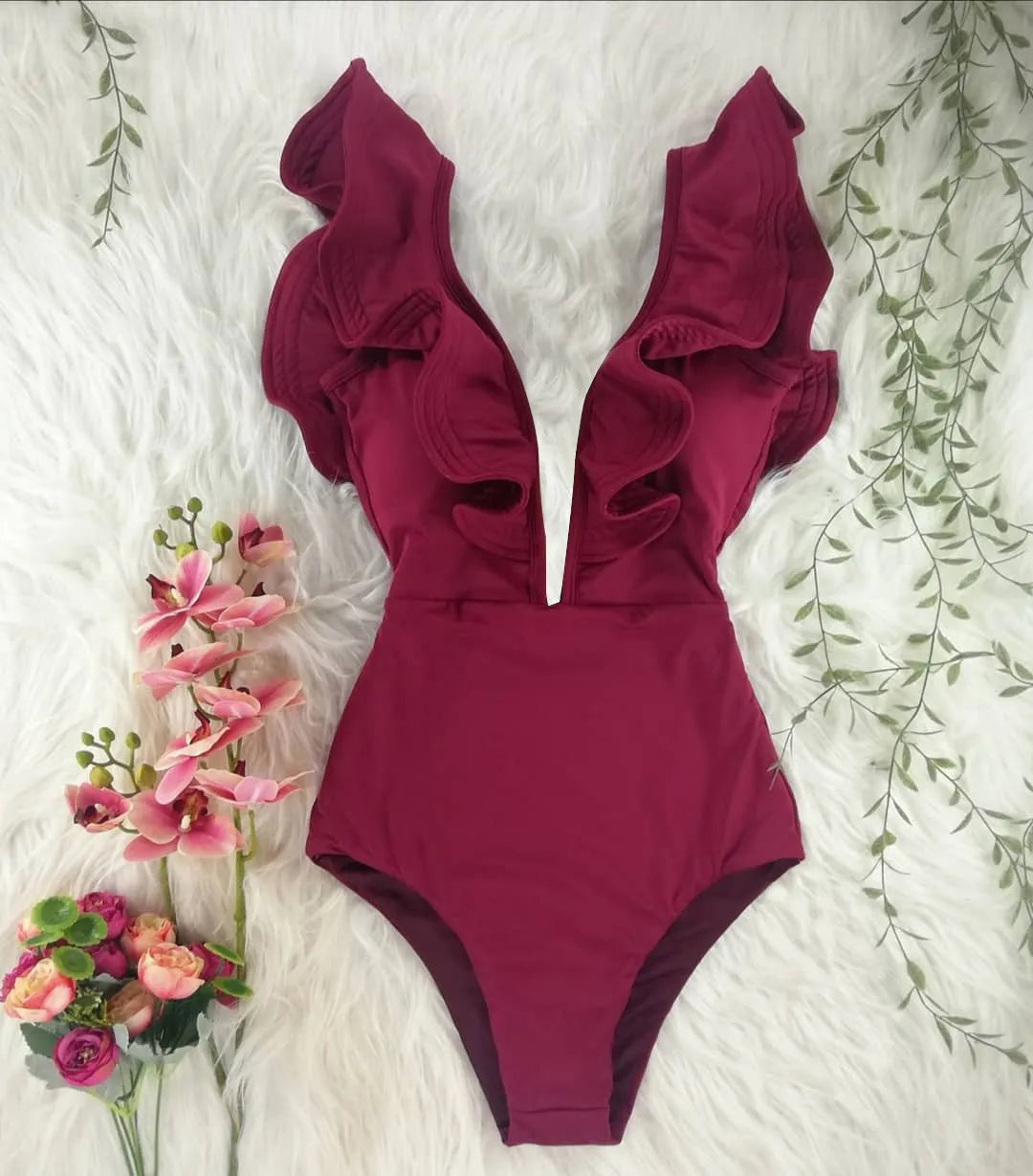 Blue printed one-piece swimsuit for women with one-shoulder ruffle and chest pad on white background