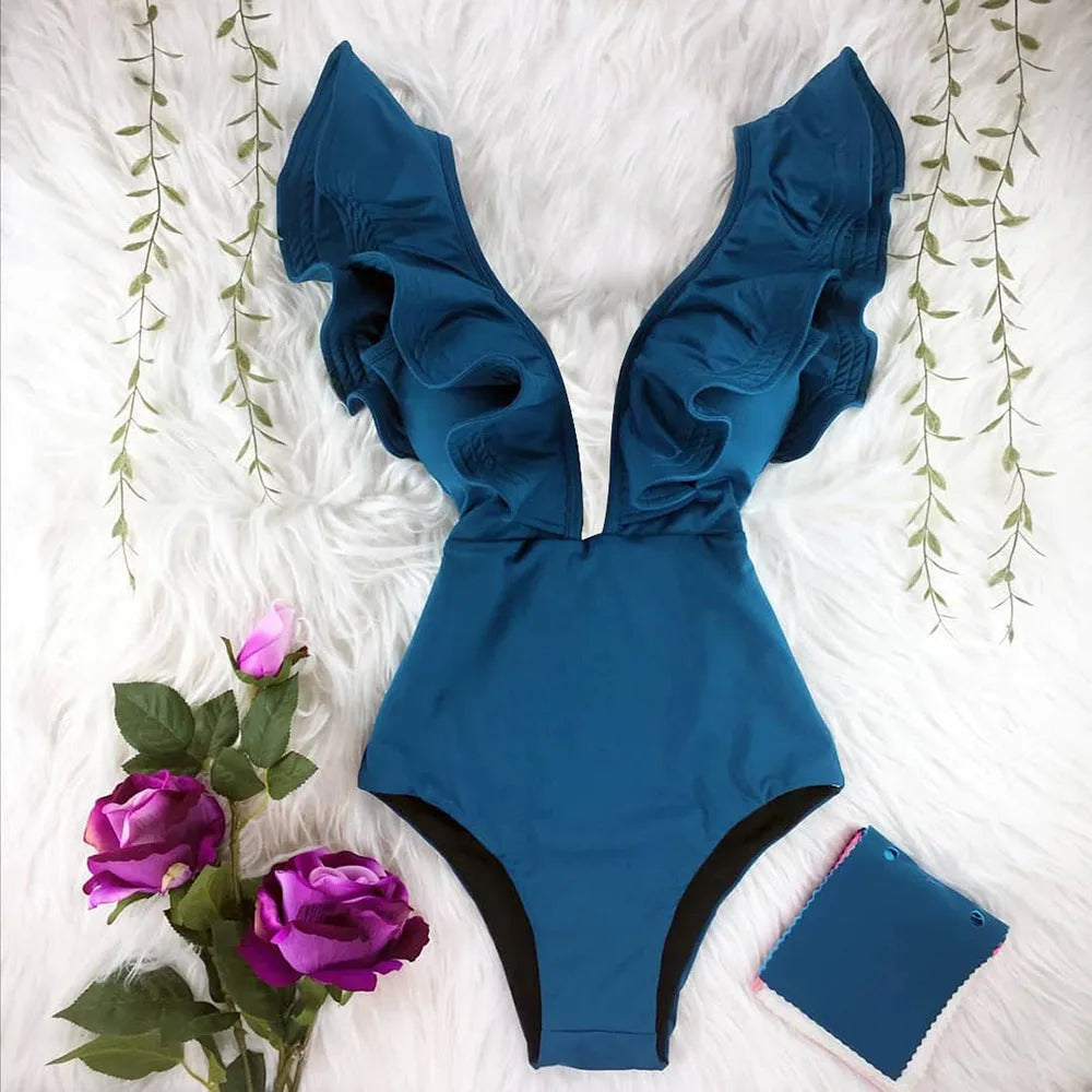Blue printed one-piece swimsuit for women with one-shoulder ruffle and chest pad on white background