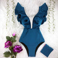Blue printed one-piece swimsuit for women with one-shoulder ruffle and chest pad on white background