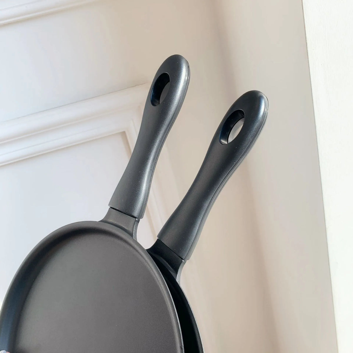 Black 3D frying pan shape iPhone case made of soft TPU and PC, back cover design.