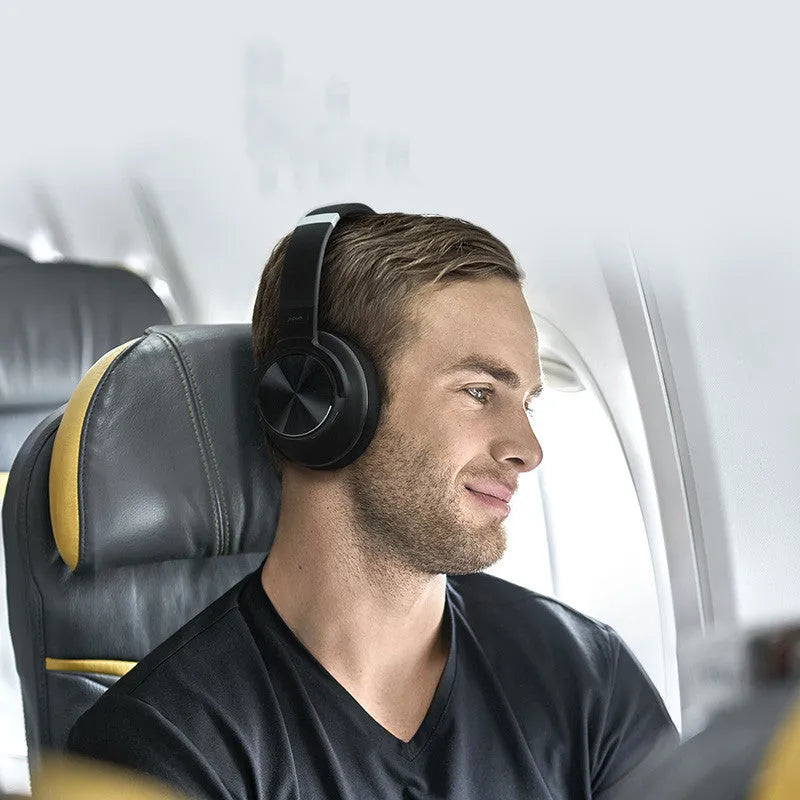 Cold black wireless Bluetooth headset with head-mounted design and all-in-ear fit for noise-cancelled listening