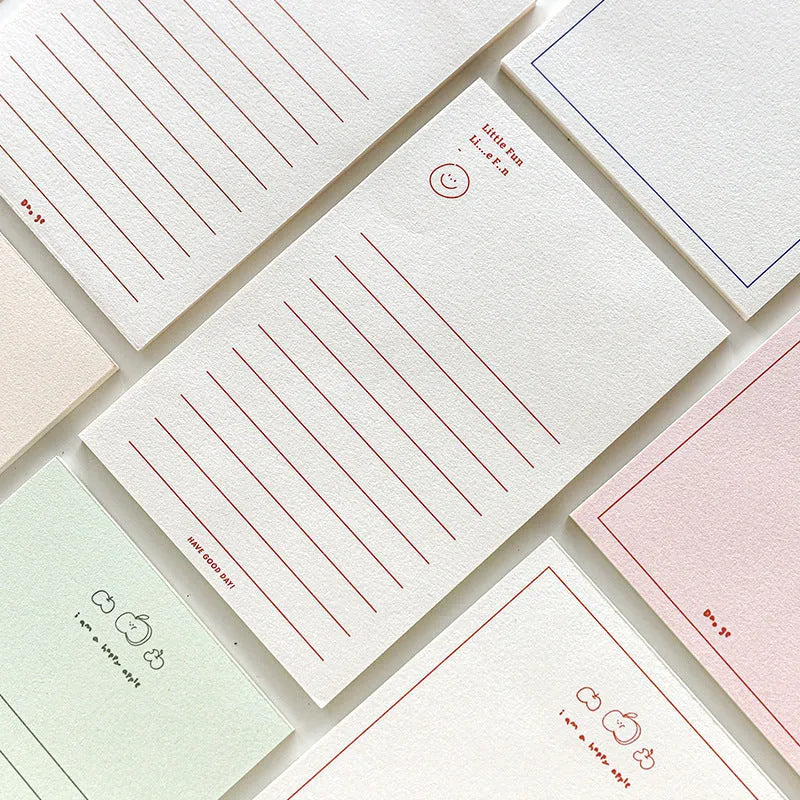 A rectangular memo pad notebook compatible with Apple iPhone, showing cover design options including blue tulip and Dogo! graphics.