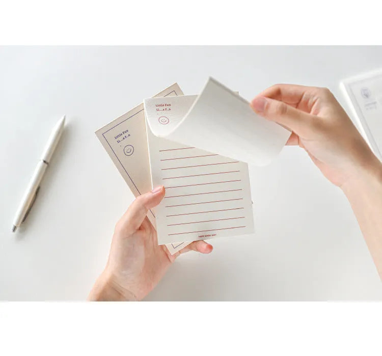 A rectangular memo pad notebook compatible with Apple iPhone, showing cover design options including blue tulip and Dogo! graphics.