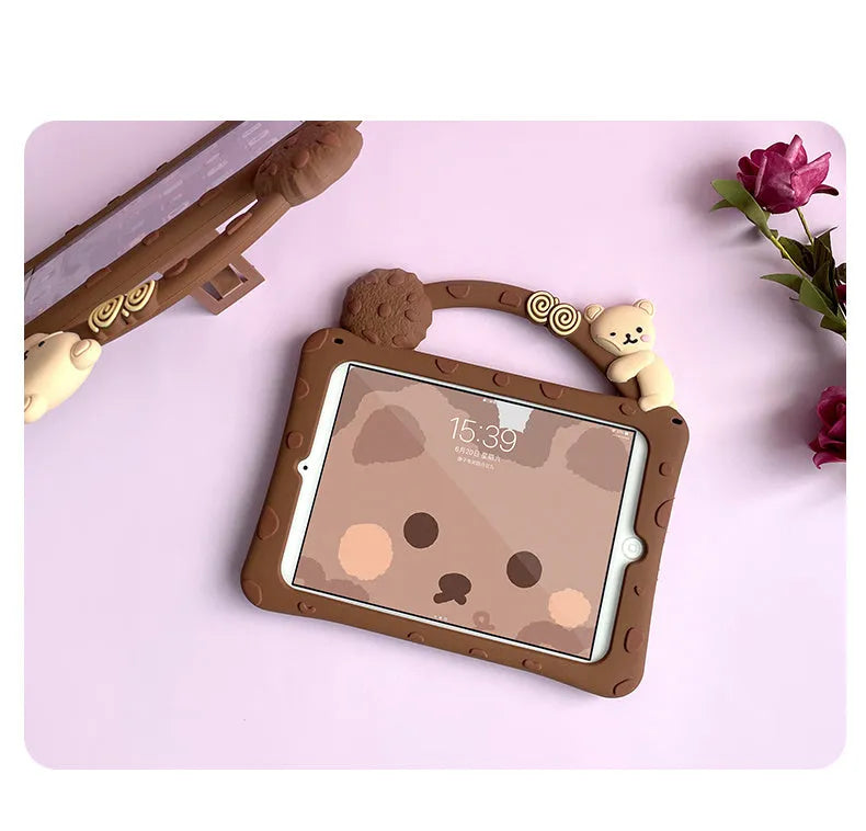 Brown cartoon silicone sleeve with stand bracket on the back, fitted on an iPad tablet.