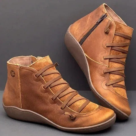 Women's casual flat ankle boots in artificial PU leather with a round toe and wedge rubber sole.