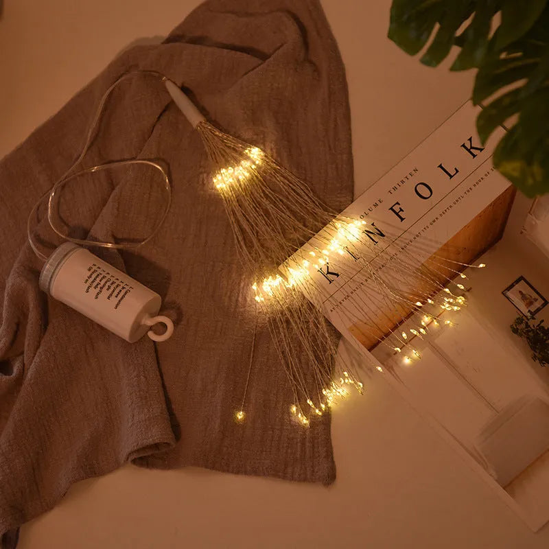 LED Meteor Shower or solar firework decoration light with multiple warm white LEDs, shown outdoors in a garden setting.
