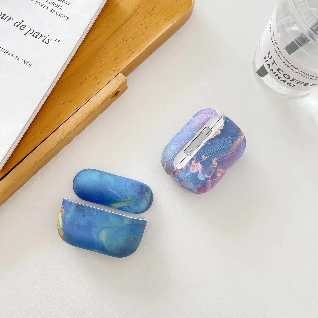 Hard plastic protective case for AirPods and AirPods Pro in a pink and blue watercolour design.