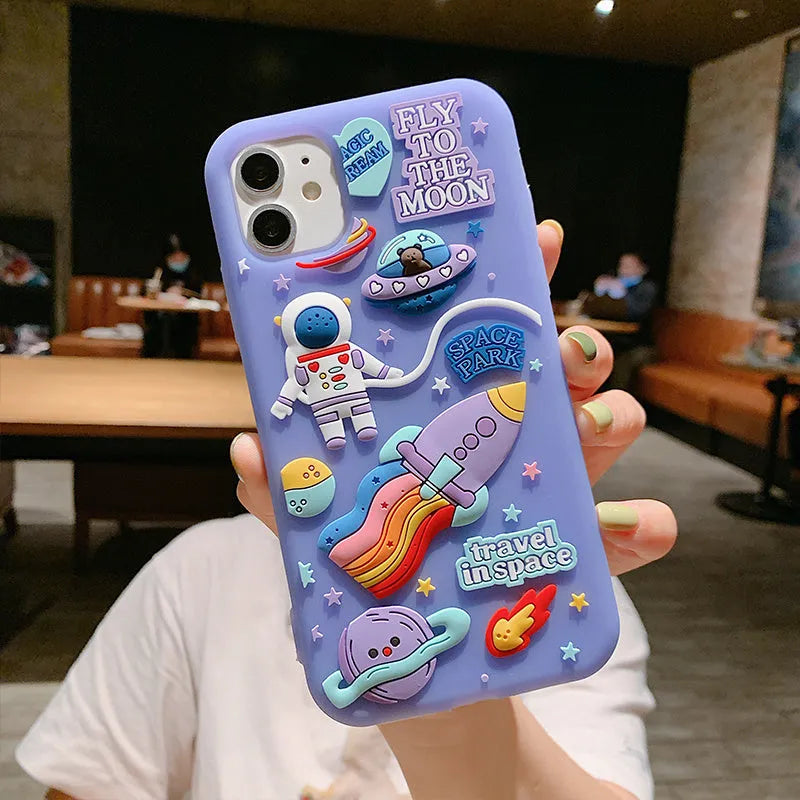 Purple silicone iPhone case with cartoon astronaut graphic for models 7, 8, X, and 11