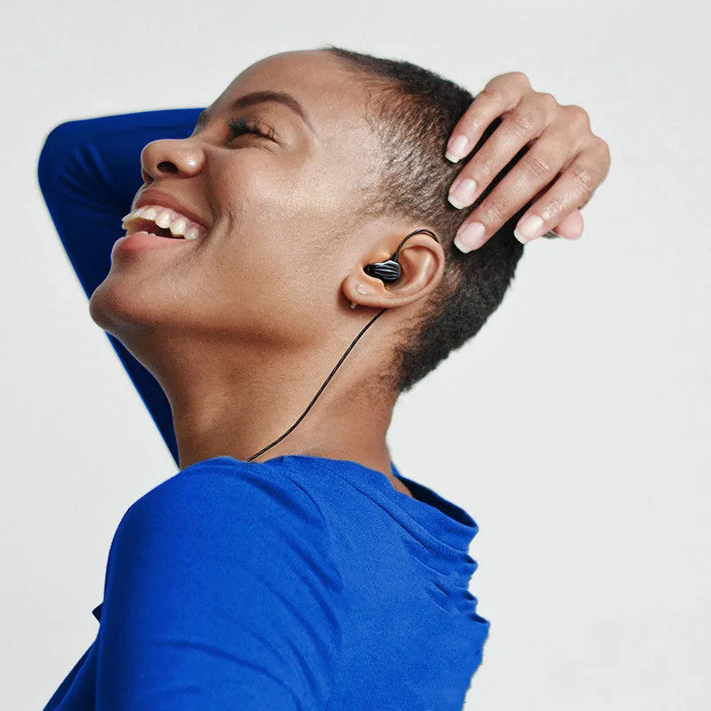White in-ear sports headphones with a black around-ear hook and 3.5mm plug on a TPE cable.