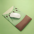 Green kiwi fruit design on a grey cloth mouse pad with a thick, curved wrist support cushion