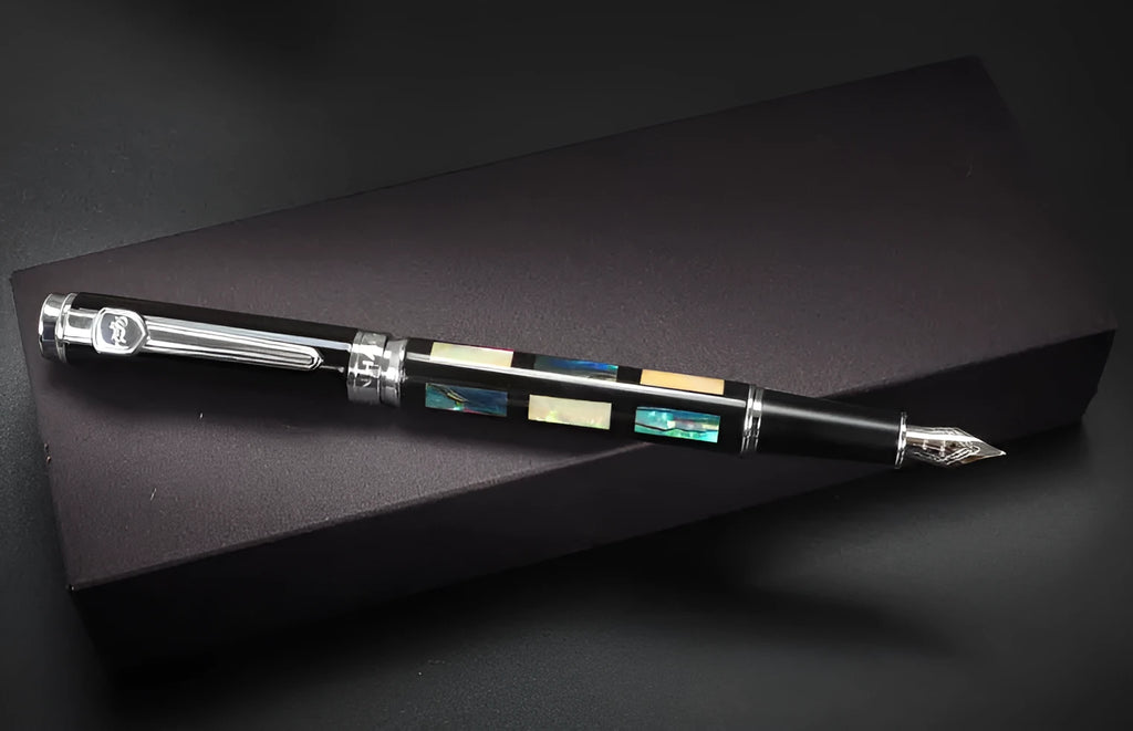 Ceramic colour lacquer pen with rotating ink system and three nib sizes in metal shell with wood finish options