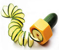 Yellow and green plastic spiral vegetable cutter on a kitchen worktop.