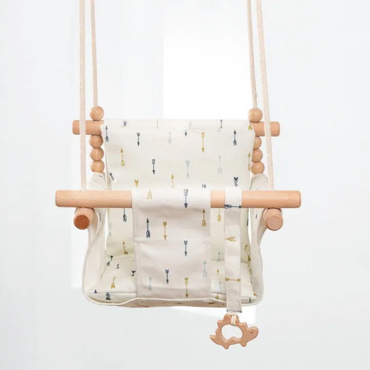 Natural cotton canvas baby swing chair with wooden seat and cushion hanging indoors