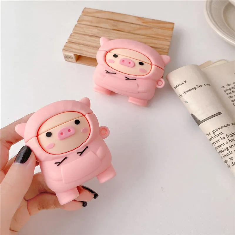 Silicone AirPods case with flip cover showing cartoon pink pig design compatible with Apple wireless headphones