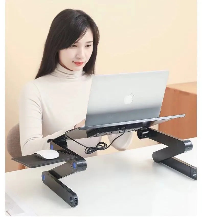 Folding black aluminium laptop cooling base with two fans and 1m power cord on a desk