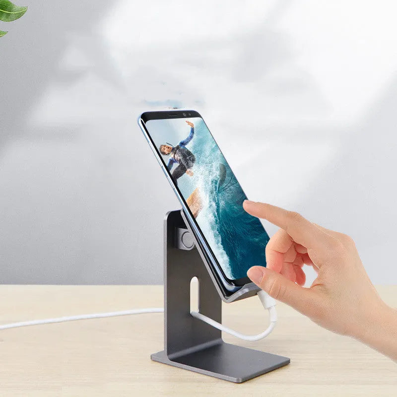 Dark Space Grey aluminium alloy mobile phone holder with adjustable lazy bracket arm and clamp on a wooden desk.