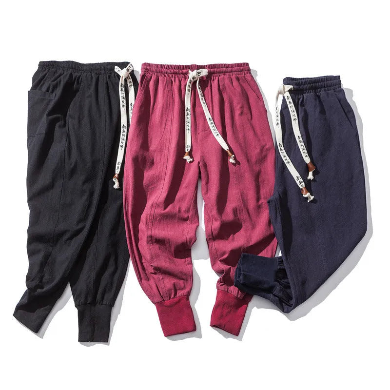 Men's black Chinese-style harem pants in linen blend, loose fit with tether closure and ankle-length cuffs