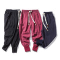 Men's black Chinese-style harem pants in linen blend, loose fit with tether closure and ankle-length cuffs