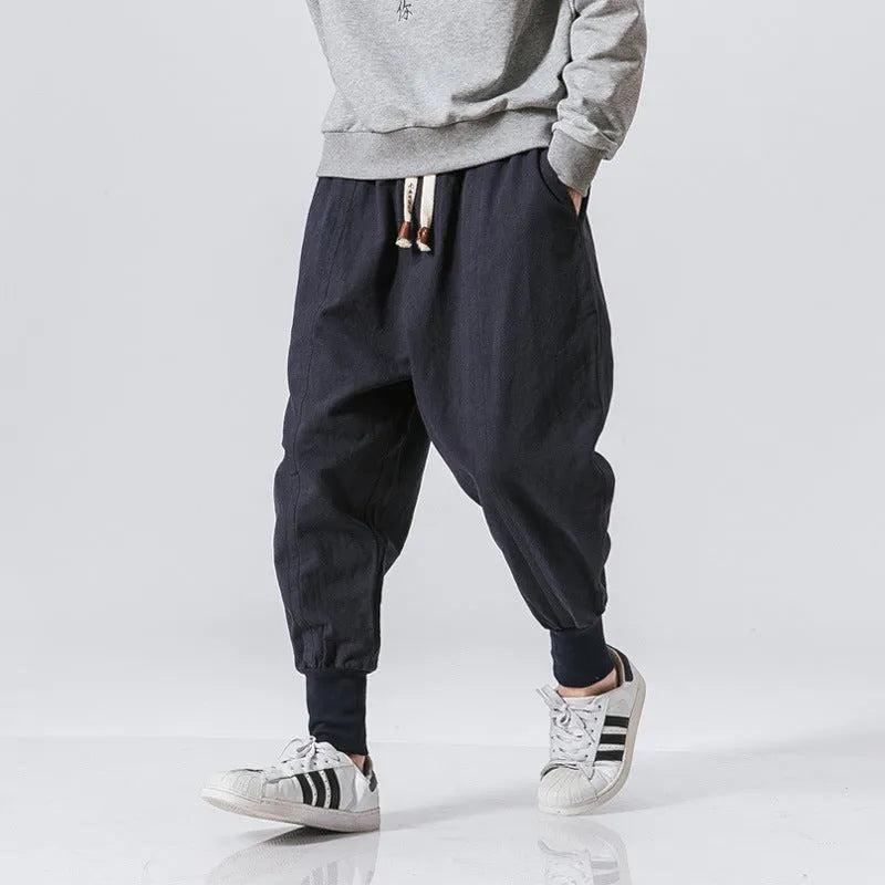 Men's black Chinese-style harem pants in linen blend, loose fit with tether closure and ankle-length cuffs