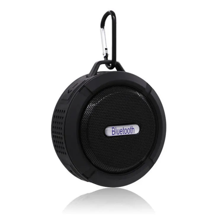 White waterproof Bluetooth speaker with a large clear suction cup on its back for wall mounting.