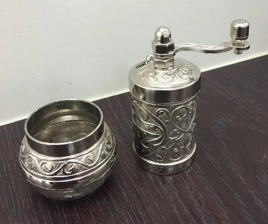 Small Turkish manual coffee grinder in silver with removable hand crank and ceramic burr