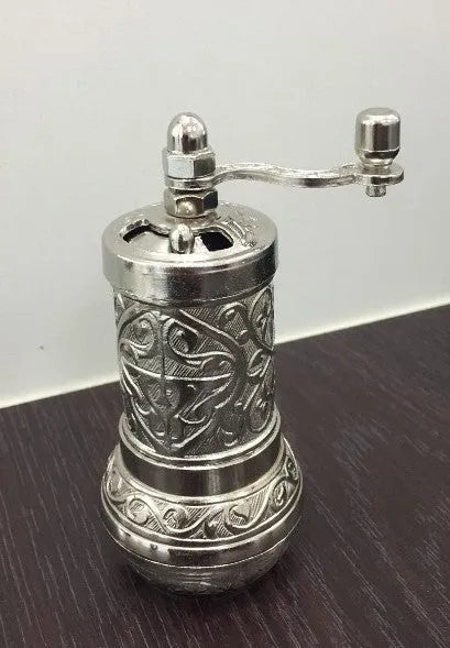 Small Turkish manual coffee grinder in silver with removable hand crank and ceramic burr