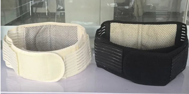 Black self-heating magnetic waist support belt fastened around a model's lower back.