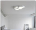 Geometric shaped iron wall light in black or white with remote control for dimming and colour change.