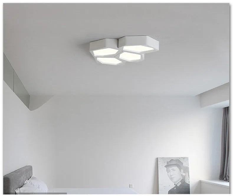 Geometric shaped iron LED light with remote control in black or white frame.