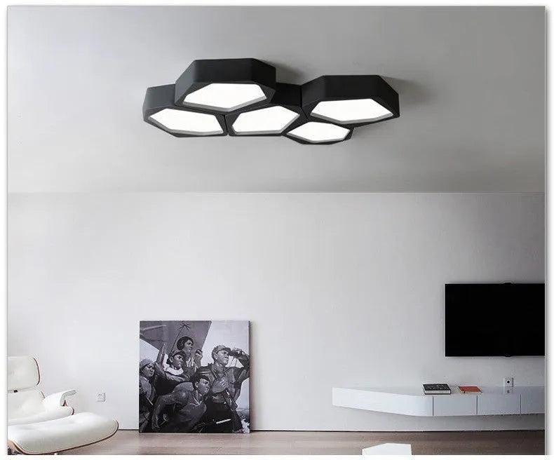 Geometric shaped iron wall light in black or white with remote control for dimming.